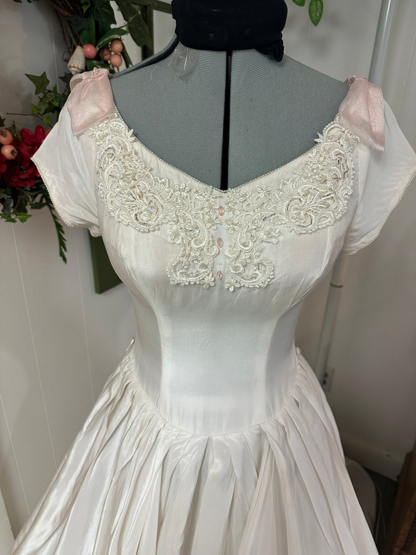 Sutton is a vintage 1950s wedding dress in pale ivory