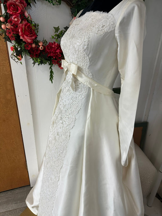 Kitty is a lovely mid century wedding gown in ivory